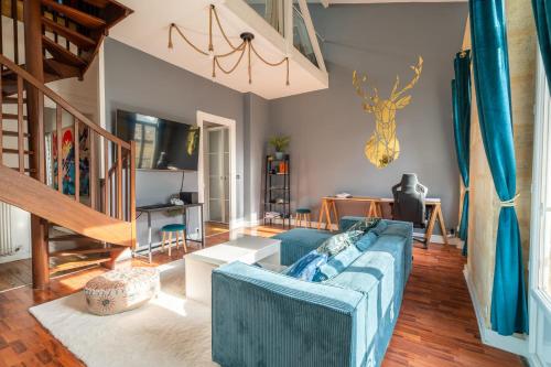 - un salon avec un canapé bleu et un escalier dans l'établissement Large bright duplex in Bordeaux, à Bordeaux