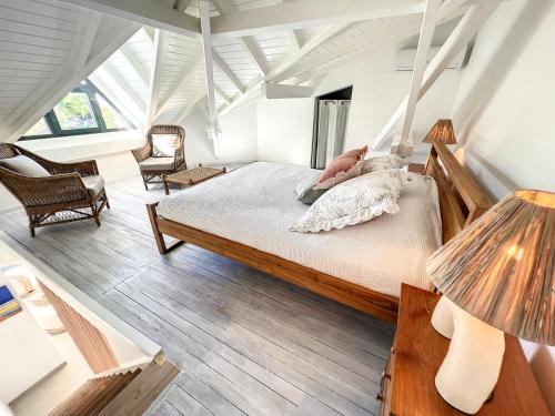 a bedroom with a bed and two lamps at Acacia Tropical, luxurious Duplex, walkable beach in Anse Marcel 