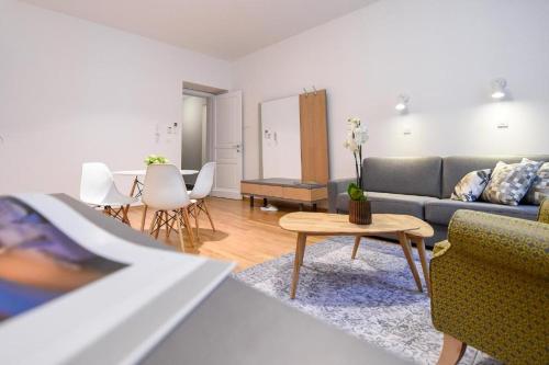 a living room with a couch and a table at City Centre Chic Apartment Ljubljana 2/4 in Ljubljana