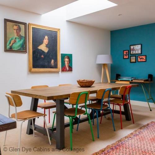 a dining room with a wooden table and chairs at Number 4 Steading Cottage in Banchory