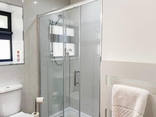 a bathroom with a glass shower with a toilet at Serenity- Uk38551 in Endon