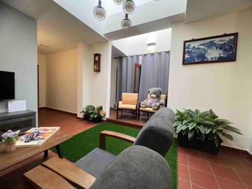 a living room with a couch and a table at New! 1min to JonkerStreet Melaka loft 4BR 11 PAX in Melaka