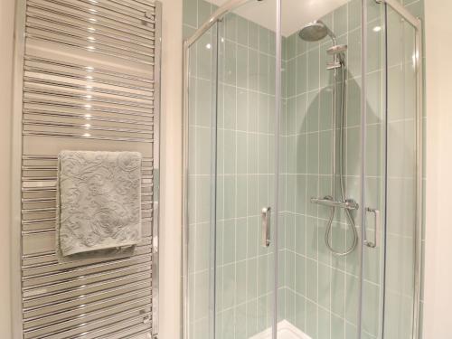 a bathroom with a shower with a glass door at Walnut View in Rugeley