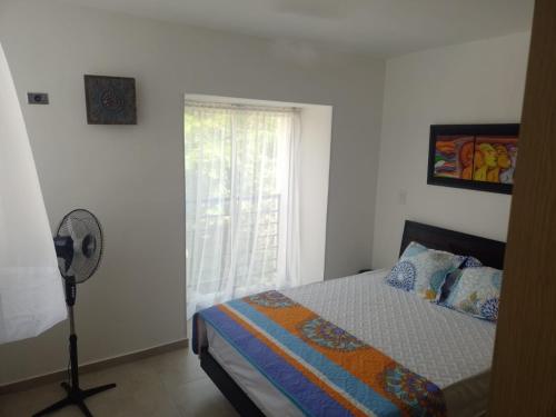 A bed or beds in a room at APARTAMENTO MELGAR - ALTAGRACIA