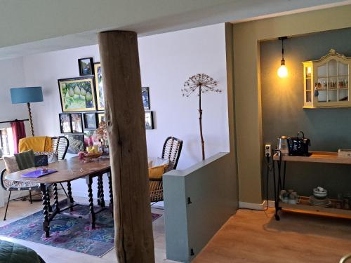 a dining room and living room with a table and chairs at Kade10Buren in Buren
