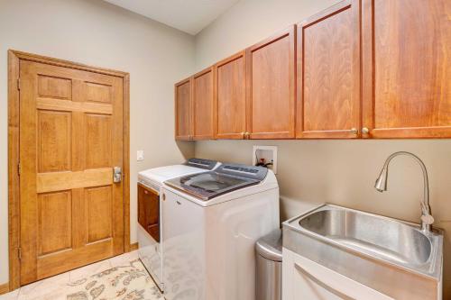 a small kitchen with a washing machine and a sink at Stunning Minneola Home with Private Pool and Yard! in Minneola