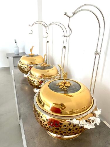 a row of gold toilets on display in a room at Luxury Farm with Swimming Pool and BBQ in Al Rahba