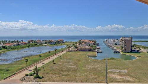 arial view of a river with buildings and the ocean at Panoramic Island View! NEW 1 BR spacious condo in beachfront resort in South Padre Island
