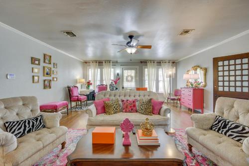 a living room with two couches and a table at The Pink Azalea - Tyler Home with Yard and Patio! in Tyler