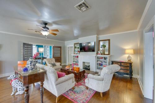 a living room with two chairs and a table at The Pink Azalea - Tyler Home with Yard and Patio! in Tyler