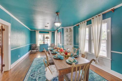 a dining room with blue walls and a table and chairs at The Pink Azalea - Tyler Home with Yard and Patio! in Tyler