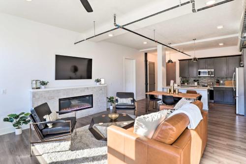 a living room with a couch and a fireplace at Walk to UNL Campus Dtwn Lincoln Loft Apt! in Lincoln