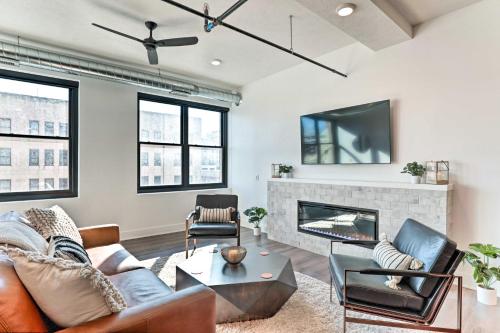 a living room with a couch and a fireplace at Walk to UNL Campus Dtwn Lincoln Loft Apt! in Lincoln