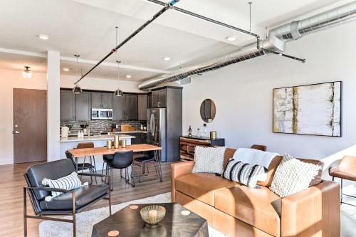 a living room with a couch and a table at Walk to UNL Campus Dtwn Lincoln Loft Apt! in Lincoln