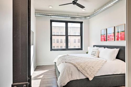 a bedroom with a bed with a ceiling fan at Walk to UNL Campus Dtwn Lincoln Loft Apt! in Lincoln