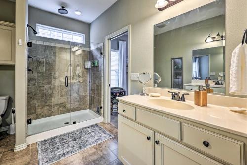 a bathroom with a shower and a sink and a tub at Fayetteville Home Near University of Arkansas! in Fayetteville