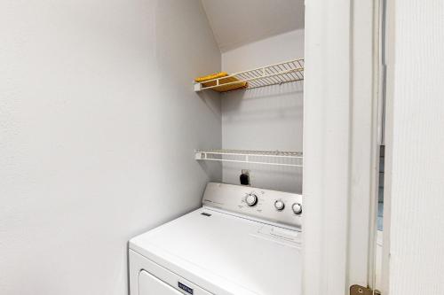 a white laundry room with a washer and dryer at Colony Club E1 in Gulf Shores