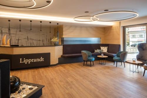 a lobby of a hotel with chairs and a couch at Hotel Lipprandt in Wasserburg