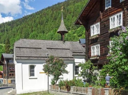 a wooden house with a steeple on a mountain at Fantastic renovated Chalet in the heart of Alps in Münster