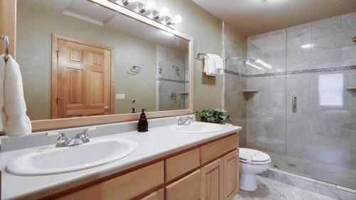 a bathroom with a sink and a toilet and a mirror at Mt. Hood 06 in Sunriver