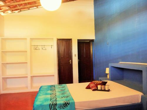 a bedroom with a bed and shelves in it at Natal Casa de Playa en Pitangui‏ in Pitangui