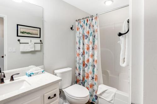 a bathroom with a toilet and a shower curtain at Gulls Nest (610) in Seaside