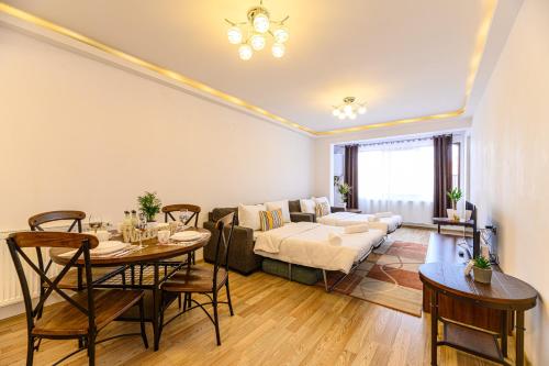 a living room with a table and a couch at JAD - Comfortable -3 Rooms & 2 Rooms Apartments in Braşov