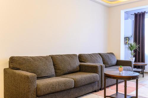 a living room with a couch and a table at JAD - Comfortable -3 Rooms & 2 Rooms Apartments in Braşov