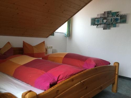 a bedroom with a bed with a colorful comforter at Haus-Fechtig-Wohnung-Typ-C in Bonndorf im Schwarzwald