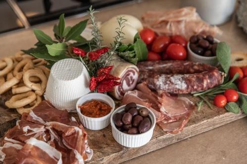 a tray of food with sausage and other foods on a table at Dimora Dei Semplici in Ostuni