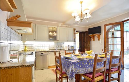 a kitchen with a table with a blue table cloth at Lovely Home In Massarosa With Wifi in Massarosa