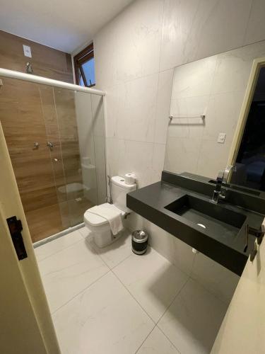a bathroom with a sink and a toilet and a shower at Terra Bella Pousada in Morro de São Paulo