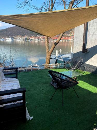 a patio with a table and a chair under a canopy at CHALET Orsova in Orşova