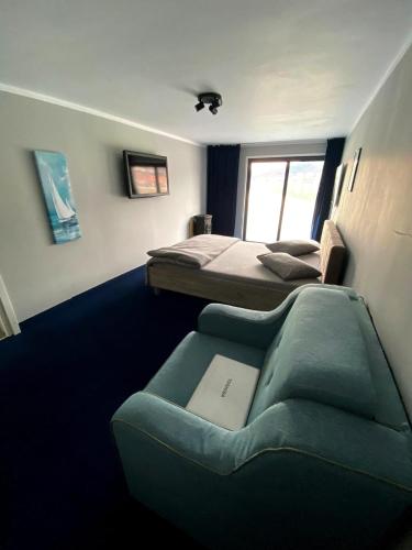 a room with two beds and a couch in it at CHALET Orsova in Orşova