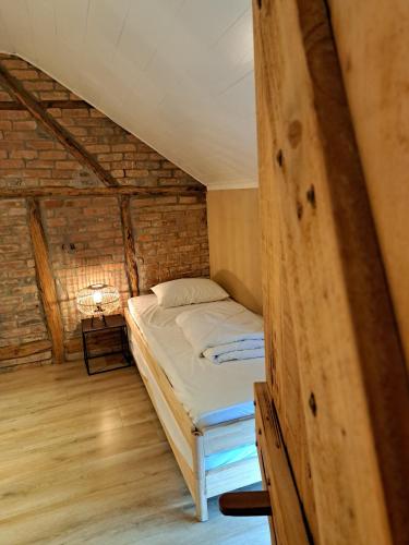 a small bedroom with a bed in a attic at La Ptit Marie in Houffalize