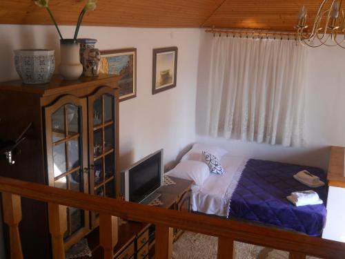 a bedroom with a bed and a desk with a computer at Apartments Ada Novak in Hvar