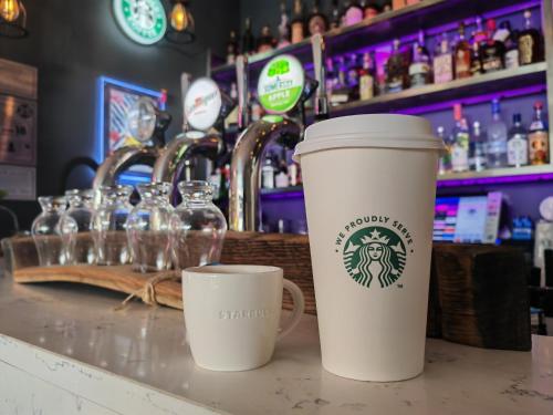 dos tazas de café sentadas en un mostrador en un bar en Seafront419 By Seafront Collection en Blackpool