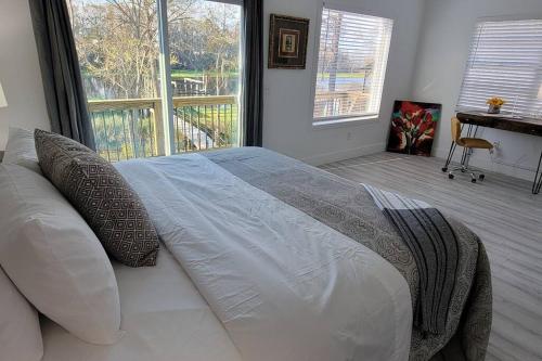 a bedroom with a bed and a large window at GOVERNOR'S CREEK~Waterfront, King Bed w/Water View in Green Cove Springs
