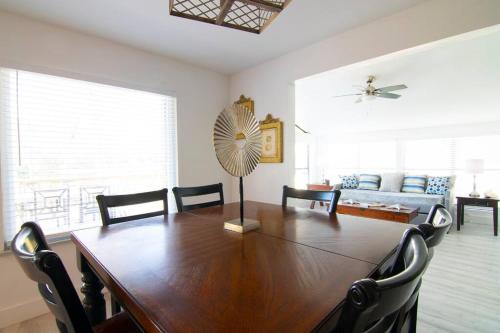a dining room with a table and a fan at GOVERNOR'S CREEK~Waterfront, King Bed w/Water View in Green Cove Springs