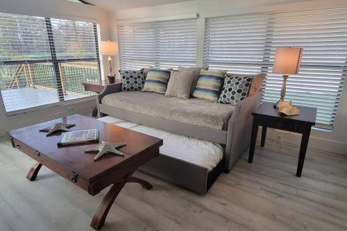 a living room with a couch and a table at GOVERNOR'S CREEK~Waterfront, King Bed w/Water View in Green Cove Springs