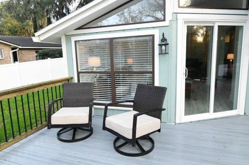 two chairs and a table on a porch at GOVERNOR'S CREEK~Waterfront, King Bed w/Water View in Green Cove Springs