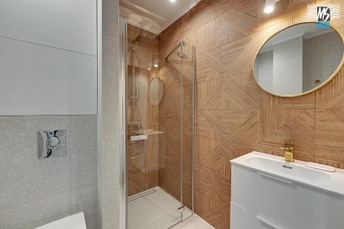 a bathroom with a shower and a sink and a mirror at MS Apartments Rest 2.0 in Sopot