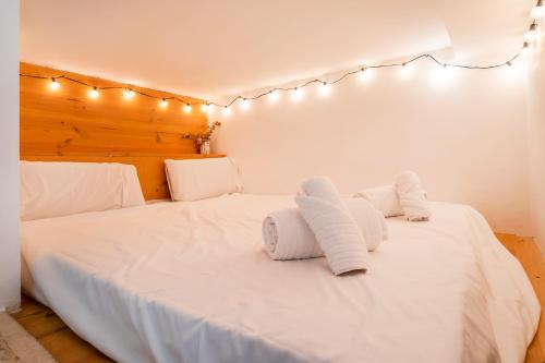 a bedroom with a white bed with towels on it at CHARMING LOFT IN RUZAFA, SOHO b2 in Valencia