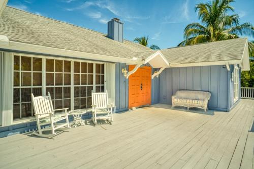 a house with two chairs and a bench on a porch at Baywatch Casa home in Captiva
