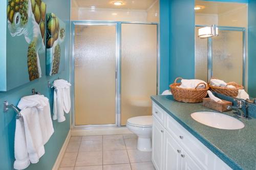 a bathroom with a shower and a toilet and a sink at Conch-Captiva Beach Villas in Captiva