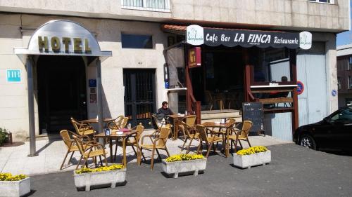 a man sitting at a table outside of a restaurant at Hotel San Jacobo in Santiago de Compostela