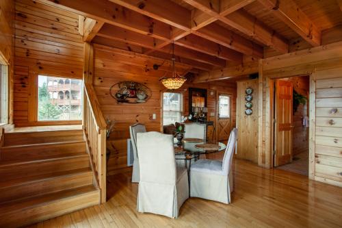 a dining room with a table and chairs in a cabin at A Shining Starr Beautiful MTN Views Hot Tub in Sevierville
