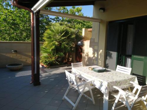 a white table and chairs on a patio at VILLA LORETTA in Torre dell'Orso