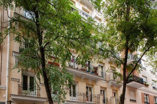 a building with balconies and trees in front of it at Luxury flat Salamanca V in Madrid