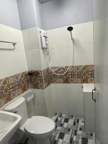 a bathroom with a shower and a toilet and a sink at เส้นดี โฮสเทล Sendee Hostel in Phitsanulok
